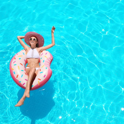 Woman enjoying clean pool with surface pool skimmer
